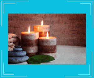 Relaxing candles next to stones. 