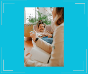 Young girl laughing during a therapy session.