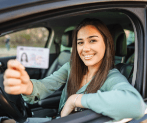 Woman showing her driver's license while in a car