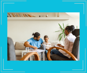 Father and son in a therapy session with a female therapist. 