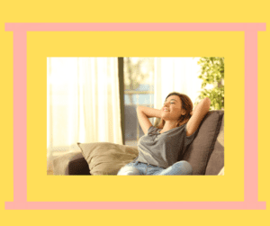 Happy, smiling woman leaning back on a comfy couch. 