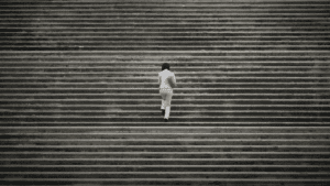 woman walking up concrete steps